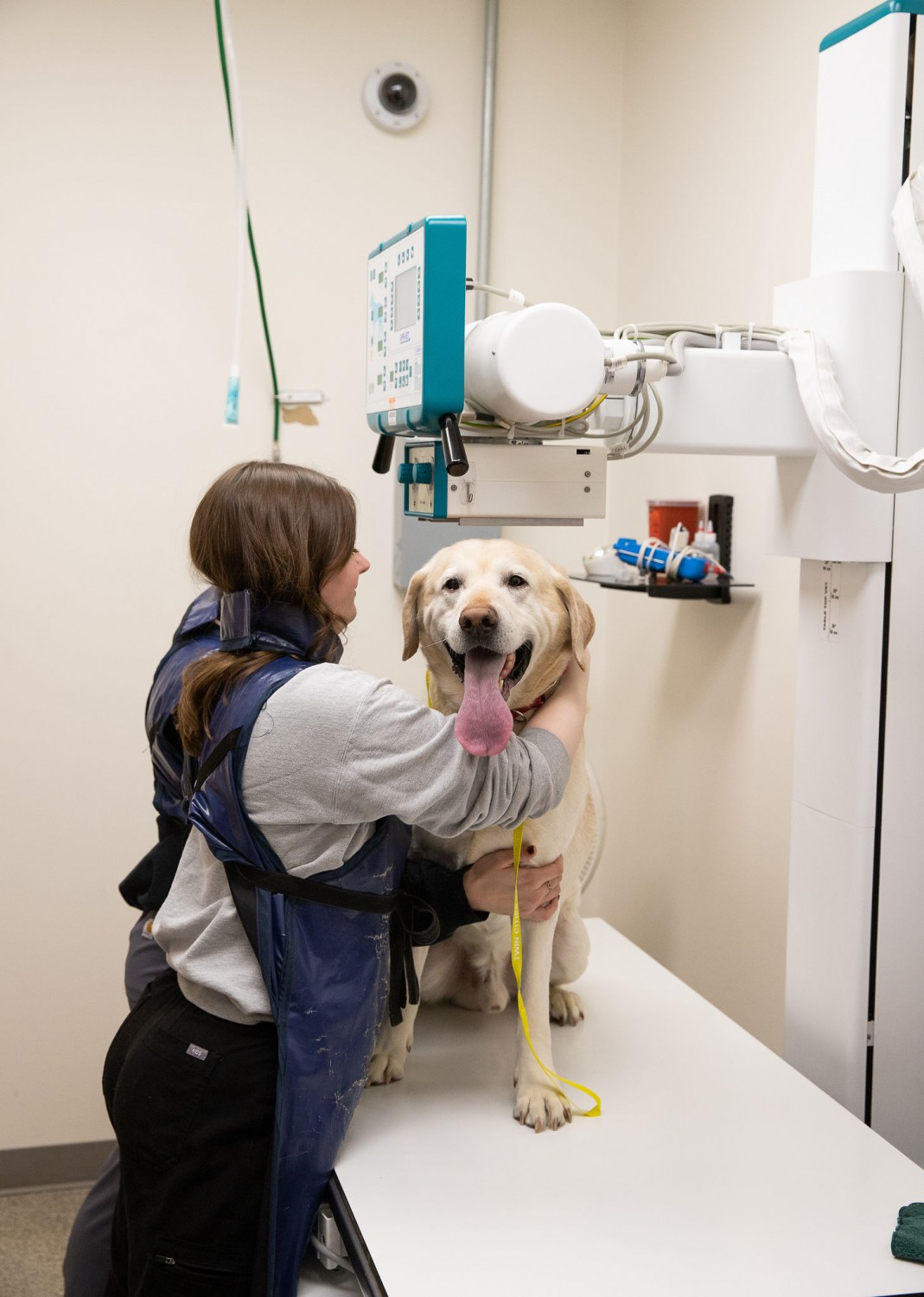 Staff with dog in radiology room